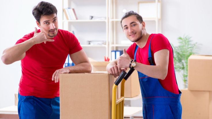 Movers carefully packing boxes